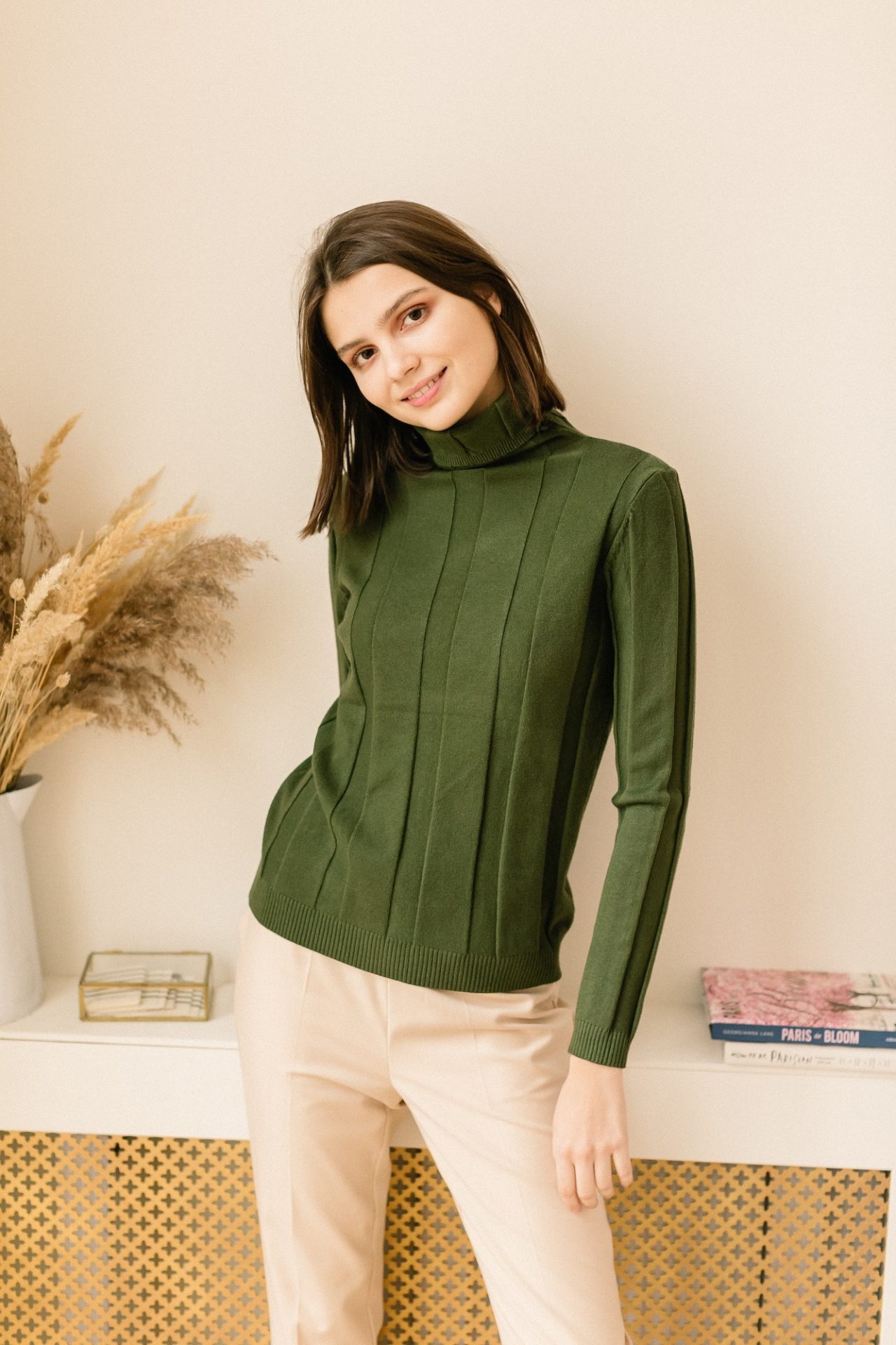 studio-portrait-of-a-young-woman-in-sweater-on-beige-background-