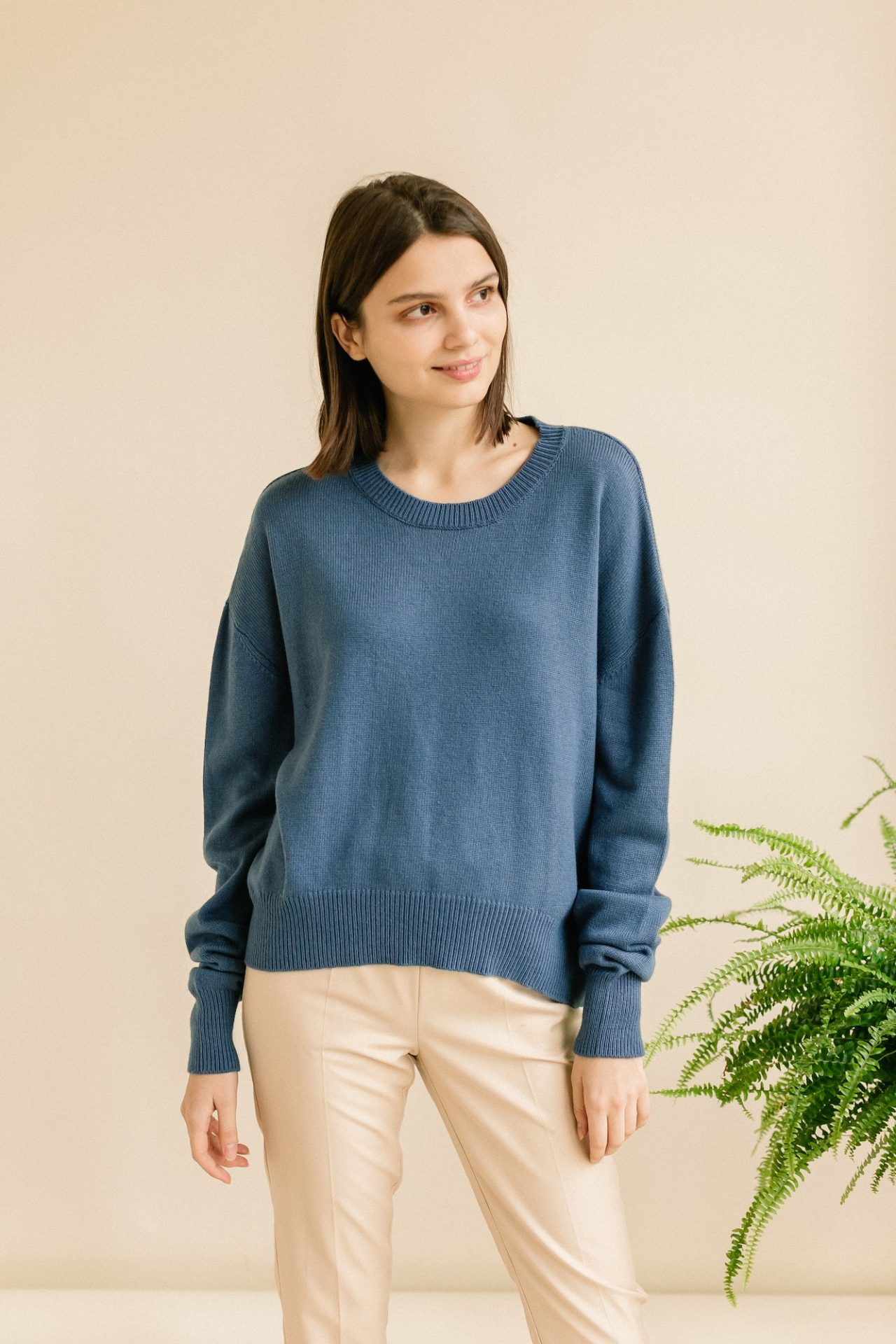 studio-portrait-of-a-young-woman-in-sweater-on-beige-background-1-1